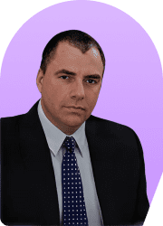 Headshot of a man in a suit and tie against a purple background.