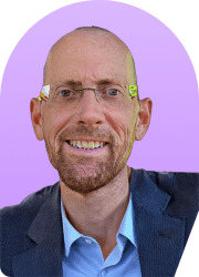 Headshot of a smiling man wearing glasses against a purple background.