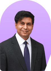 Headshot of a man in a suit against a purple background.