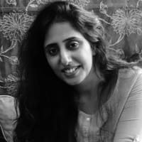 Black and white headshot of a woman with long hair.
